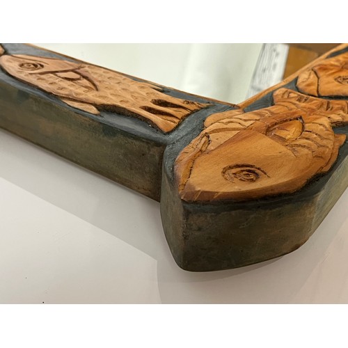 139 - Contempery hand carved wooden framed mirror, decorated with fish. 63 cm x 56 cm x 5 cm.

This lot is... 