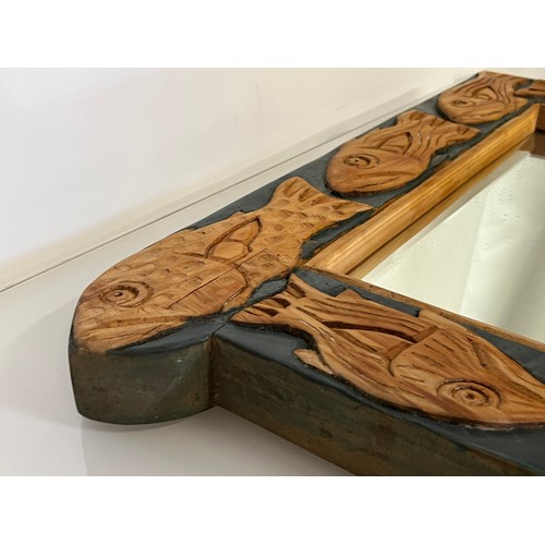 139 - Contempery hand carved wooden framed mirror, decorated with fish. 63 cm x 56 cm x 5 cm.

This lot is... 