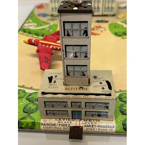 375 - Lithographed tinplate clock work model Airport with circling plane, in original box. 38 cm x 25 cm.
... 