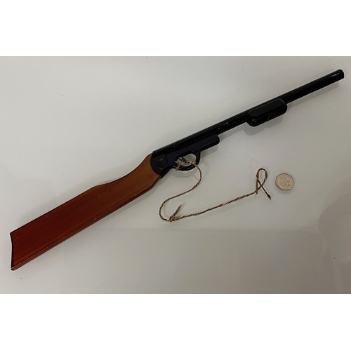 376 - A toy Pop Gun, a pump action reload mechanism aids rapid reloading, wooden butt and enamelled steel ... 