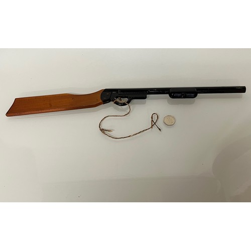 376 - A toy Pop Gun, a pump action reload mechanism aids rapid reloading, wooden butt and enamelled steel ... 