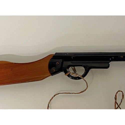 376 - A toy Pop Gun, a pump action reload mechanism aids rapid reloading, wooden butt and enamelled steel ... 