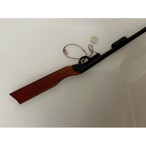 376 - A toy Pop Gun, a pump action reload mechanism aids rapid reloading, wooden butt and enamelled steel ... 