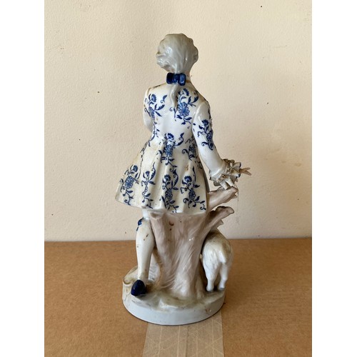 276 - Porcelain figurine marked with a crown to the base.

This lot is available for in-house shipping