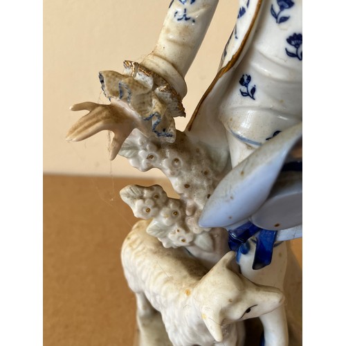 276 - Porcelain figurine marked with a crown to the base.

This lot is available for in-house shipping