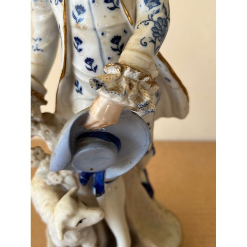 276 - Porcelain figurine marked with a crown to the base.

This lot is available for in-house shipping