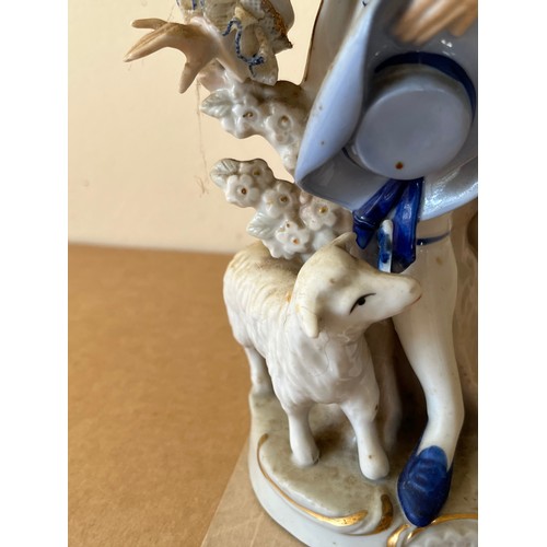 276 - Porcelain figurine marked with a crown to the base.

This lot is available for in-house shipping