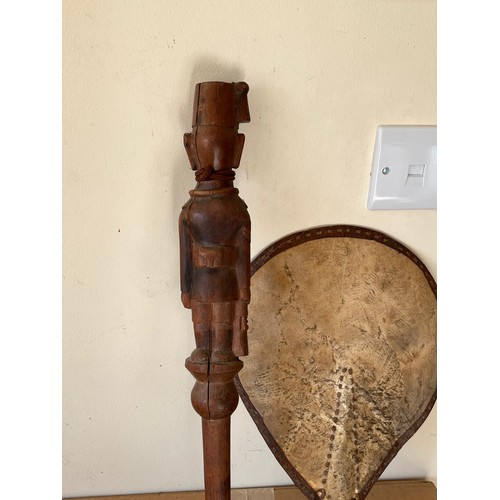 277 - Variety of tribal art pieces, an Armadillo bag, a stick carved with a military figure and a hide fan... 