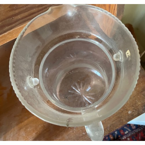 282 - An Edwardian clear glass cooling jug with wheel cut decoration.

This lot is available for in-house ... 