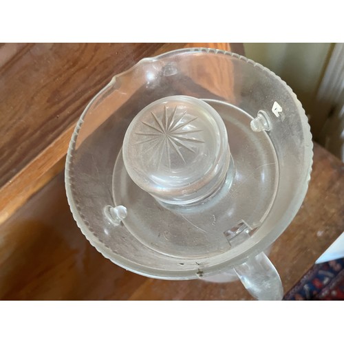 282 - An Edwardian clear glass cooling jug with wheel cut decoration.

This lot is available for in-house ... 