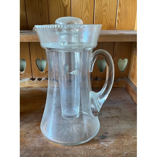 282 - An Edwardian clear glass cooling jug with wheel cut decoration.

This lot is available for in-house ... 