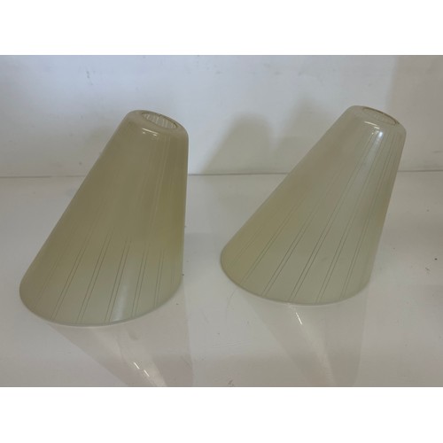 284 - A pair of mid century glass shades 15 cm high.

This lot is available for in-house shipping