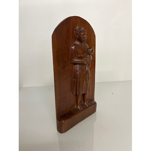 296 - A free standing hand carved wooden panel depicting a black mother holding a young child. 20 cm x 40 ... 