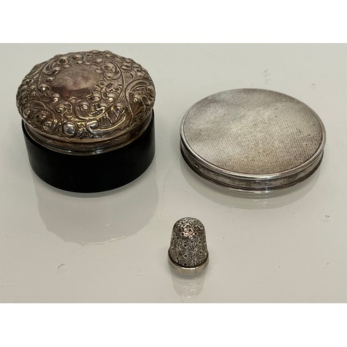 301 - Dressing table silver wares, a hallmarked compact and thimble and treen pot with a repousee lid.