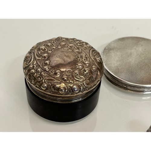 301 - Dressing table silver wares, a hallmarked compact and thimble and treen pot with a repousee lid.