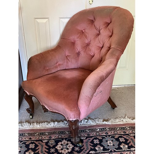 34 - An upholstered Victorian armchair with a tubed back and serpentine front on carved legs, 67 cm wide ... 