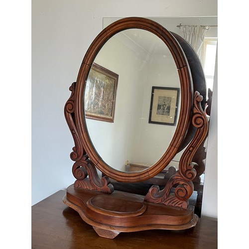 340 - A Victorian dressing table mirror, an oval framed mirror on carved supports, 73 cm high x 55 cm wide... 