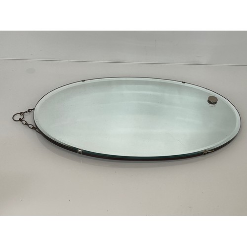 385 - Bevel edged oval wall mirror. 55 cm x 32.5cm, can be hung in a portrait or landscape style.

This lo... 