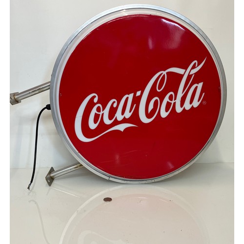 18 - Coca Cola double sided illuminated shop sign 60 cm in diameter 

This lot is available for in-house ... 