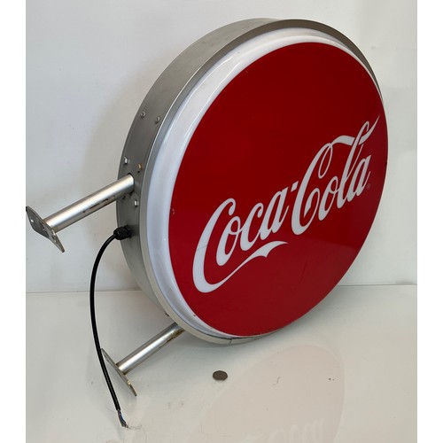 18 - Coca Cola double sided illuminated shop sign 60 cm in diameter 

This lot is available for in-house ... 
