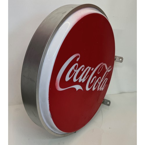 18 - Coca Cola double sided illuminated shop sign 60 cm in diameter 

This lot is available for in-house ... 