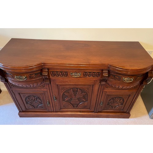 55 - A bow front sideboard with carved decoration and two bow front drawer sections. 150 cm wide x 54 cm ... 