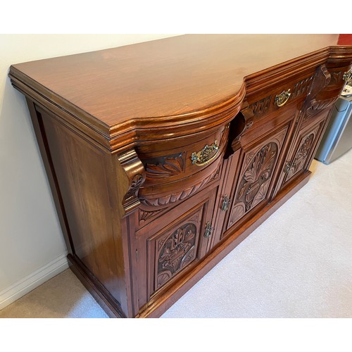 55 - A bow front sideboard with carved decoration and two bow front drawer sections. 150 cm wide x 54 cm ... 