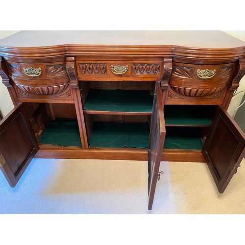 55 - A bow front sideboard with carved decoration and two bow front drawer sections. 150 cm wide x 54 cm ... 