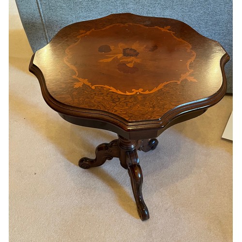 58 - Inlaid side table raised on a single column support with three feet. 54 cm wide and 63 cm tall.

Thi... 