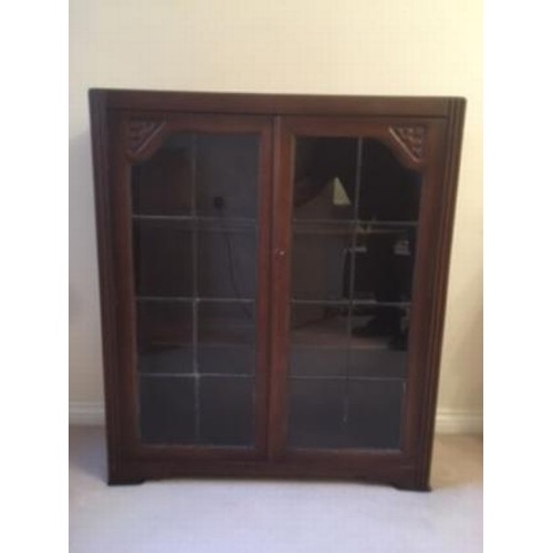 64 - Glazed two door cupboard with two internal shelves. 91 cm x 30 cm  x 106 cm high.

This lot is colle... 