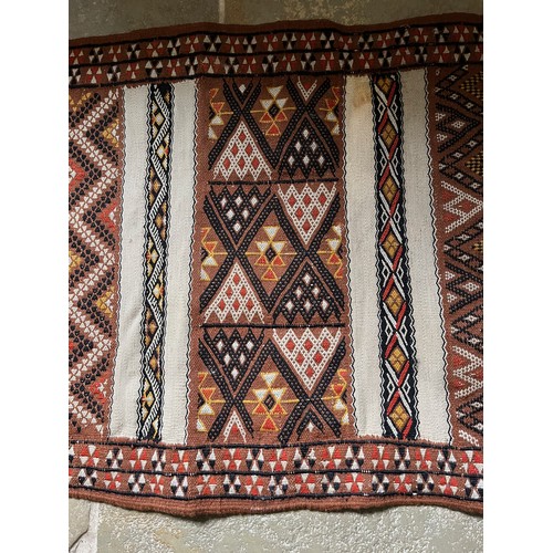 157 - A hand tied floor rug with a geometric design, 2 metres x 70 cm wide.

This lot is available for in-... 