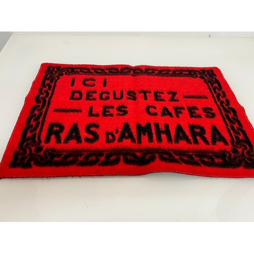 159 - A woven mat advertising Coffee Ras D’Amhara. 58 cm x 43 cm.

This lot is available for in-house ship... 