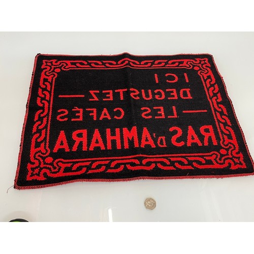 159 - A woven mat advertising Coffee Ras D’Amhara. 58 cm x 43 cm.

This lot is available for in-house ship... 