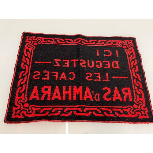 159 - A woven mat advertising Coffee Ras D’Amhara. 58 cm x 43 cm.

This lot is available for in-house ship... 