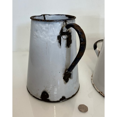 168 - Two vitrous enamels jugs. 28 cm tall and 23cm tall.

This lot is available for in-house shipping