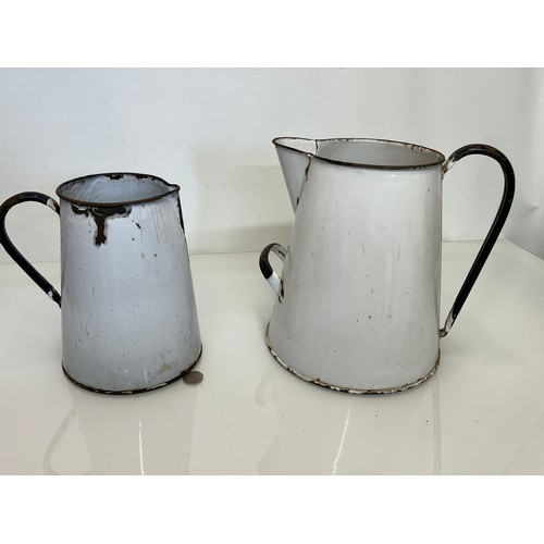 168 - Two vitrous enamels jugs. 28 cm tall and 23cm tall.

This lot is available for in-house shipping