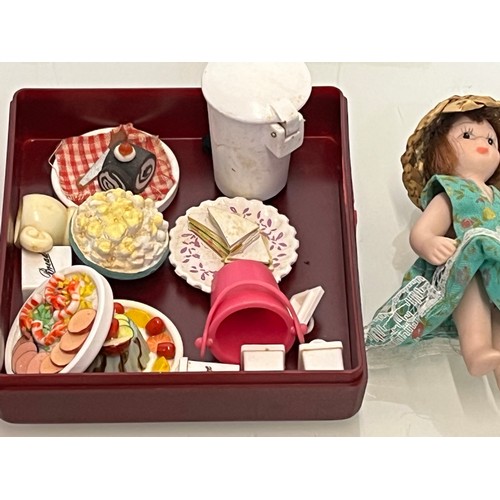 206 - A collection of dolls house accessories and table wares and two dolls.

This lot is available for in... 