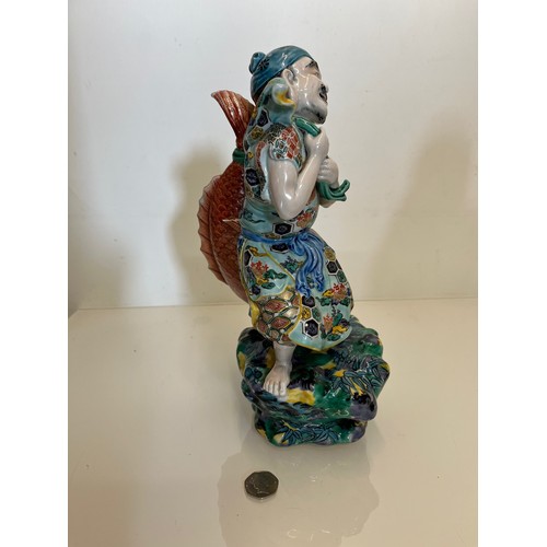 445 - Oriental figure of a Fisherman, 32 cm high.

This lot is available for in-house shipping