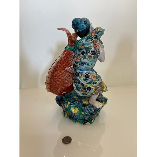 445 - Oriental figure of a Fisherman, 32 cm high.

This lot is available for in-house shipping