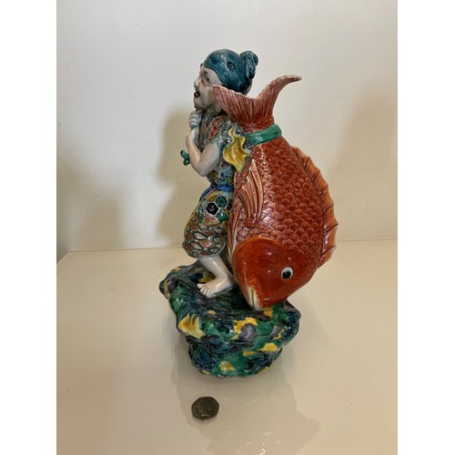 445 - Oriental figure of a Fisherman, 32 cm high.

This lot is available for in-house shipping