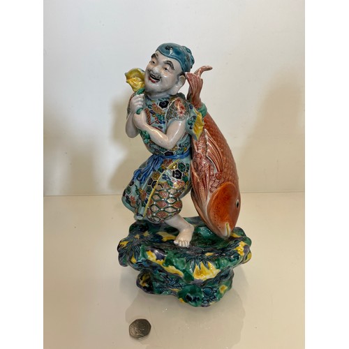 445 - Oriental figure of a Fisherman, 32 cm high.

This lot is available for in-house shipping