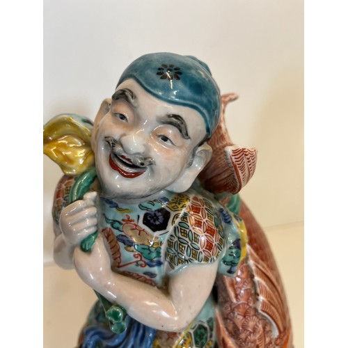 445 - Oriental figure of a Fisherman, 32 cm high.

This lot is available for in-house shipping