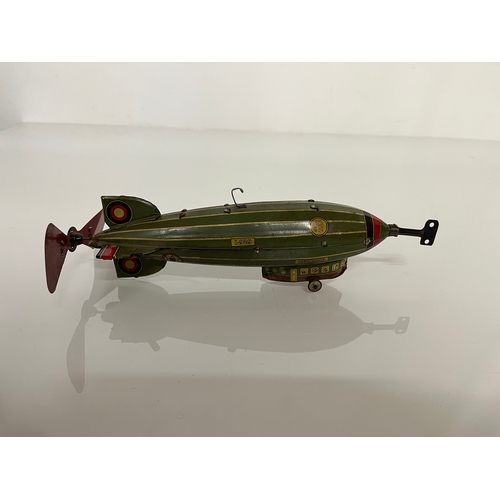 370 - Lithographed tin plate clockwork toy zepplin. 23 cm long.

This lot is available for in house shippi... 