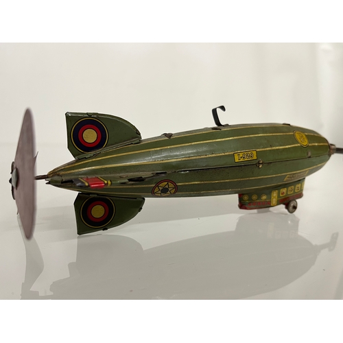 370 - Lithographed tin plate clockwork toy zepplin. 23 cm long.

This lot is available for in house shippi... 