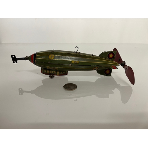 370 - Lithographed tin plate clockwork toy zepplin. 23 cm long.

This lot is available for in house shippi... 