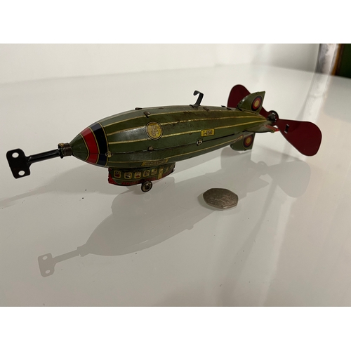 370 - Lithographed tin plate clockwork toy zepplin. 23 cm long.

This lot is available for in house shippi... 