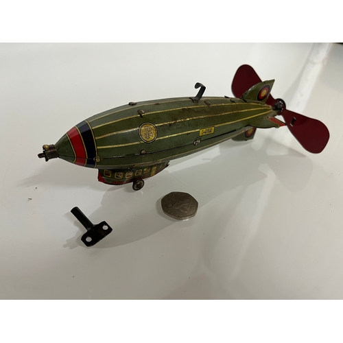 370 - Lithographed tin plate clockwork toy zepplin. 23 cm long.

This lot is available for in house shippi... 