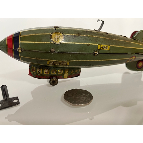 370 - Lithographed tin plate clockwork toy zepplin. 23 cm long.

This lot is available for in house shippi... 