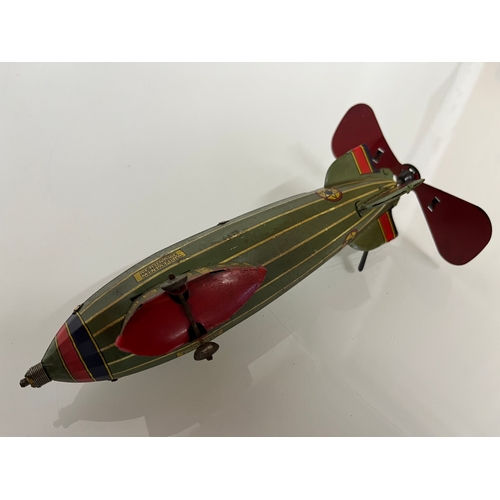 370 - Lithographed tin plate clockwork toy zepplin. 23 cm long.

This lot is available for in house shippi... 