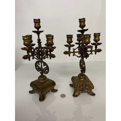 177 - A pair of ornate cast  brass four branch candlelabras.

This lot is available for in house shipping ... 